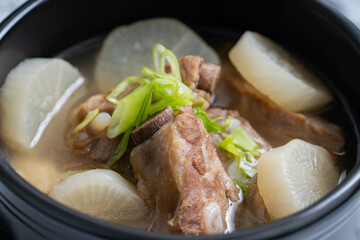 pork bone soup with sliced radish and scallions 