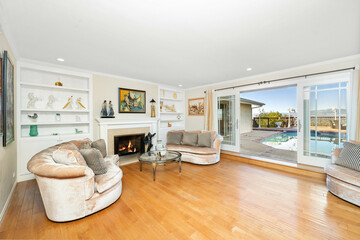 Living room with a fireplace, sofas, and TV in Encino, CA