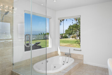 Spacious white bathtub in a bathroom beside a window in Hidden Hills, CA