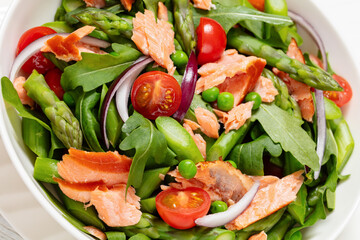 smoked salmon salad with spring veggies in bowl
