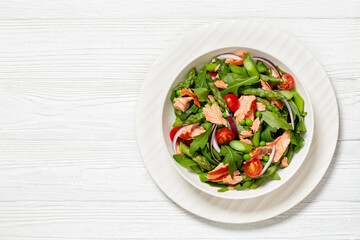 smoked salmon salad with spring veggies in bowl