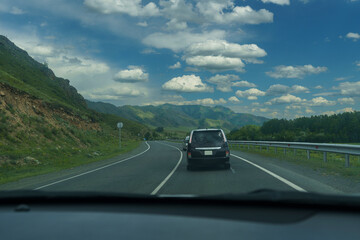 feelings of speed due to smeared roadsides and nature when driving fast on a highway with a blue sky