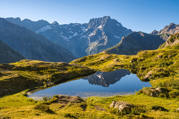 Ecrins National Park and Lauzon Lake in summer with a view of the Sirac mountain peak. The lake is...