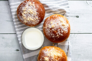 Fresh buns with milk. on a wooden background. dinner
