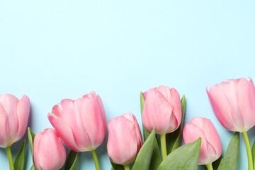 Happy Mother's Day. Beautiful pink tulips on light blue background, flat lay. Space for text