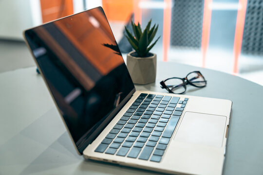 Office table, laptop, glasses on the table, business concept, stock photo