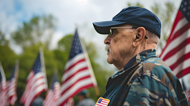 Photo of gerra veterans paying tribute to fallen soldiers on Memorial Day, standing in front of U.S. flags