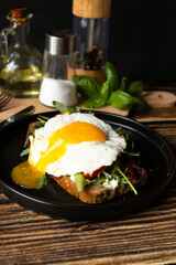 Sandwich with egg. on a wooden background. breakfast