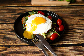 Sandwich with egg. on a wooden background. breakfast