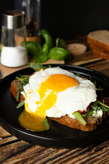 Sandwich with egg. on a wooden background. breakfast