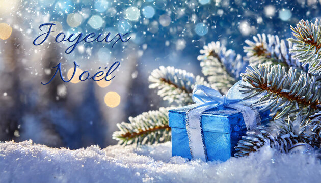 carte ou bandeau pour souhaiter un Joyeux Noël en bleu représenté par un cadeau bleu posé dans la neige et derrière des branches de sapin givrées sur un fond bleu avec des ronds en effet bokeh