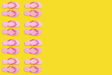 Creative beach slippers pattern on yellow background. Summer minimal concept.