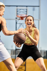 Two young athletic women standing together, with one holding a basketball, ready to play basketball outside on a sunny day in summer.
