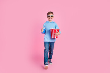 Full size photo of funky little boy hold popcorn soda can walk empty space watch movie 3d glasses...