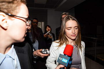 Confident female US politician answers press questions and gives interview for media walking in...