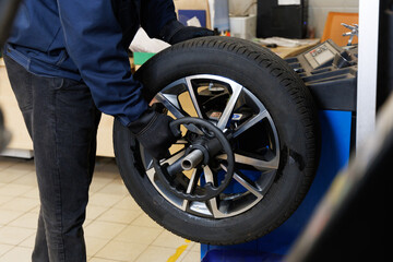 Mechanic balancing a tire in auto repair shop