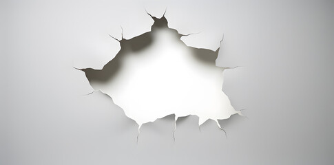 White wall with a large hole with torn edges background. Large torn hole in the center of the white background