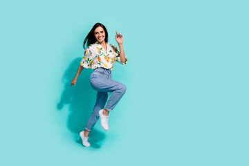Fototapeta na wymiar Full length photo of cheerful funky girl wear comfort clothes hurrying mall center running empty space isolated on cyan color background