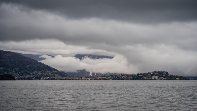 panorama of lake Maggiore on a rainy day with heavy low clouds covering part of the coast