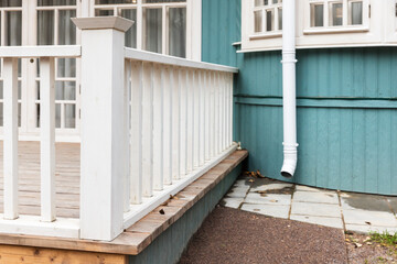 Obraz premium Rural wooden house exterior details, white terrace railings