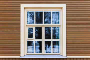 Window with white frame in a beige wooden wall - 782084182