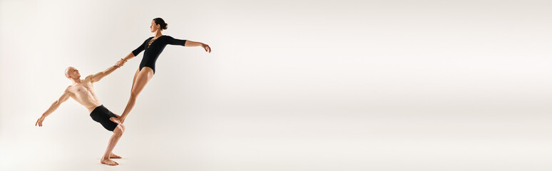 A shirtless young man and a young woman perform acrobatic elements in mid-air, showcasing a graceful and mesmerizing dance routine.