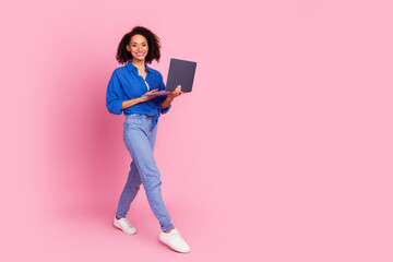 Photo of pretty lovely woman wear stylish blue clothes use device macbook walk empty space isolated...