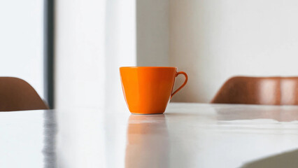 orange cup of coffee or tea on a white table in a white room, interior, minimalism, copy space, banner