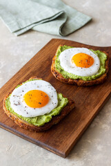 Toast with guacamole and eggs. Healthy eating. Breakfast.