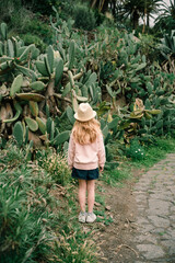 girl wearing a straw hat in the garden of cactuses on Tenerife © Tina