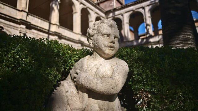 A cherub in the garden of the Basilica of St Mark Evangelist at Campidoglio. Rome, Italy