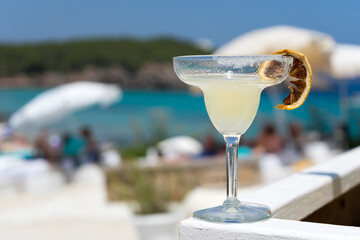 Margarita cocktail with lemon slice served at beach club on Mediterranean island of Ibiza. Fun....