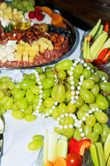 vegetables, fruits and snacks on the dinner table with jewelry pearl