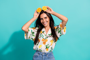 Photo of charming lovely girl wear stylish outfit hands hold juicy mandarin look up empty space isolated on bright cyan color background