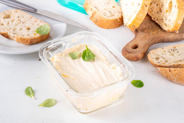 Homemade Vegan Butter, non-dairy creamy, plant based alternative butter with soy bean leave, and home baked bread on kitchen white table background