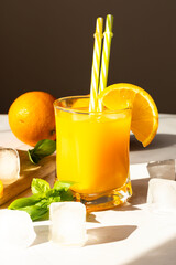 Fototapeta premium A glass of fresh orange juice. on a white table. drink.
