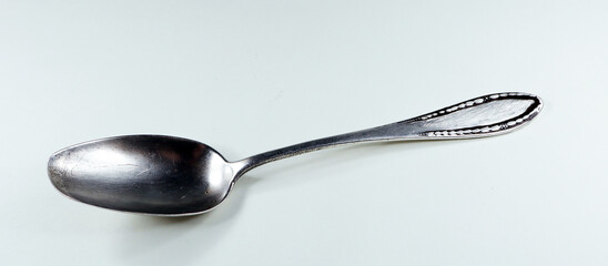Antique vintage retro silver spoon isolated on white close-up