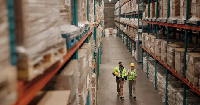 Distribution, logistics and stock with warehouse team walking together to check supply chain storage. Delivery, product or shelves with man and woman in factory for collaboration on tablet in plant