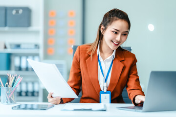 In Asian legal compliance, faculty of law, legal counseling office, a female lawyer reads a contract, advising on legal matters. clients, ensuring agreements align with laws and regulations, online