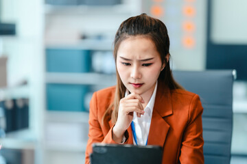 In Asian legal compliance, legal counseling office, a female lawyer reads a contract, advising on...