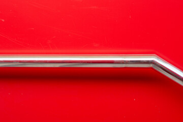 Steel handrail on a red background art creative copy space.