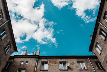 view from below on the tenement houses and the sky