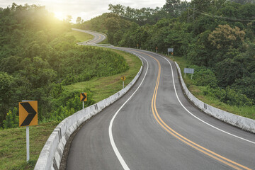 Beautiful curved road in the mountains with sunset. - 782153313
