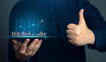 Businessman showing growth charts and thumbs up. Success in business and economics. Successful...