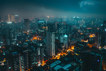 Fototapeta premium Aerial view of a cityscape at night with illuminated streets and buildings, showcasing the urban glow against a dark, moody sky.