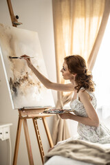 Beautiful female painter enjoying while painting in home art studio. Woman Artist Works on Abstract acrylic painting in the art studio - 782160327