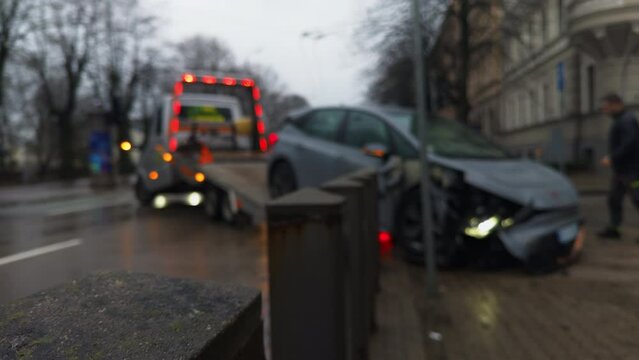 Blurred image shows car accident on city street involving vehicle and tire