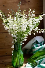 Türaufkleber Bouquet white flowers Lily of the valley in glass ( Convallaria majalis, May bells, may-lily ) on a white table with space for text © Svetlana