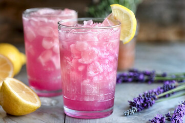 Pink lemonade with lavender, lemon, crushed ice. Refreshing summer cocktail made from natural ingredients.