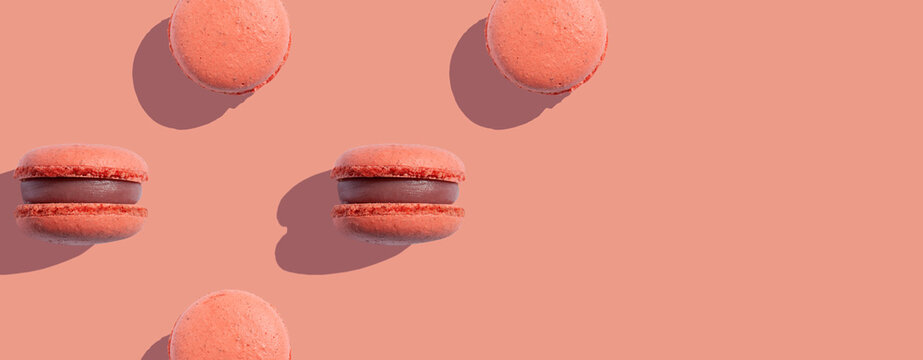 Seamless pattern with macaroons on a coral background